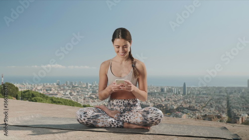 Photography Woman looking at smartphone screen in city