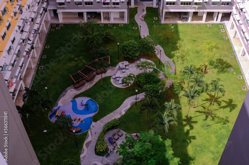 Photography Aerial view of common green space in block of public housing in Singapore heartland canberra estate on sunny day