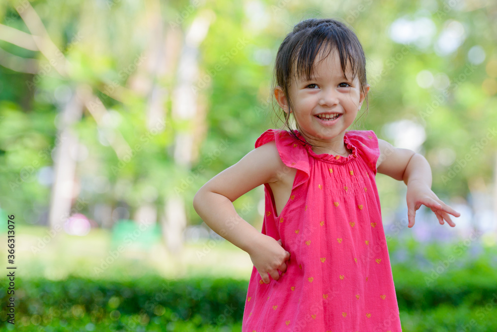 Happy young adorable multi ethnic girl smiling at the park outdoors Happy young adorable multi ethnic girl smiling at the park outdoors
