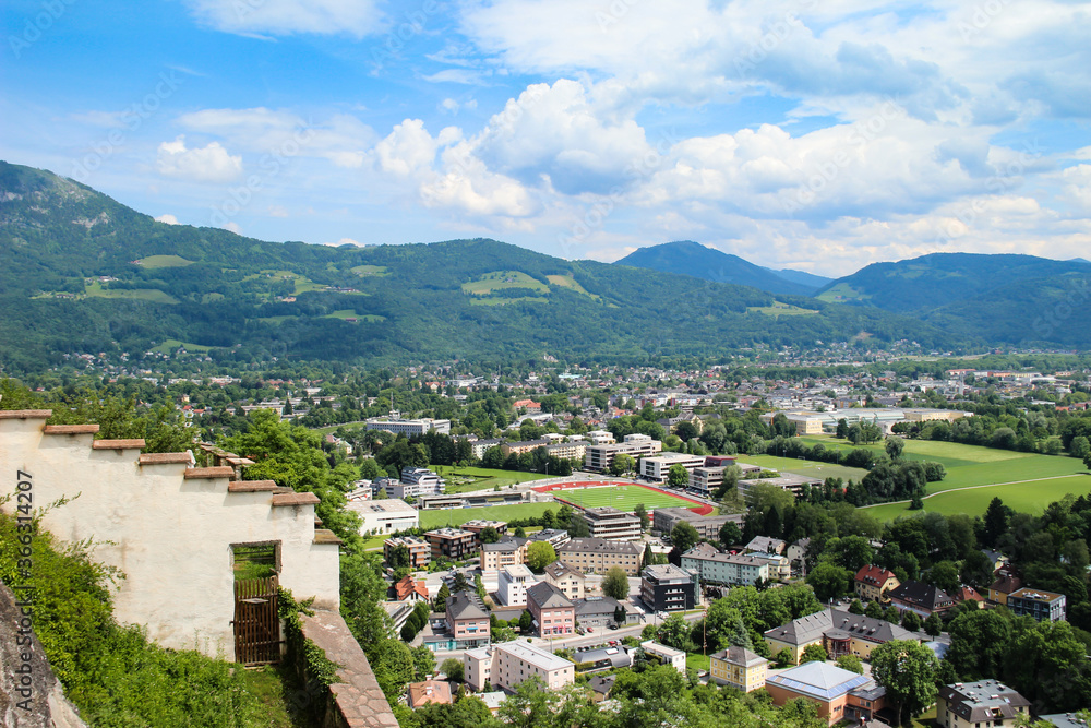 Beautiful cityscape of Salzburg, Austria. Panorama of the city and Alpsfrom above. Beautiful view of buildings and hills on the horizon. 