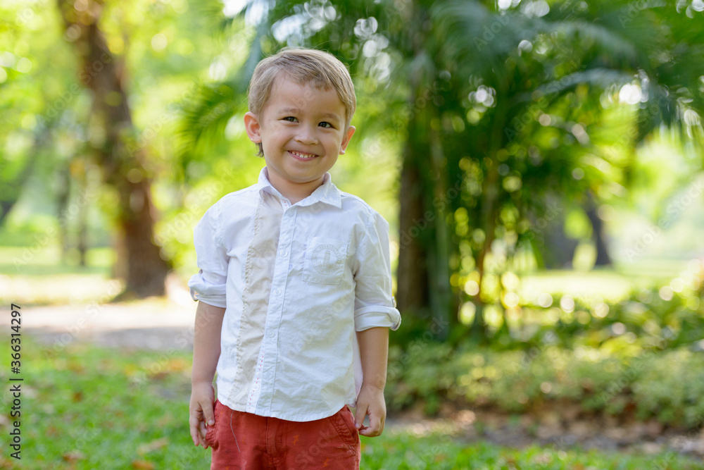 Young adorable little boy with blond hair at the park outdoors Young adorable little boy with blond hair at the park outdoors