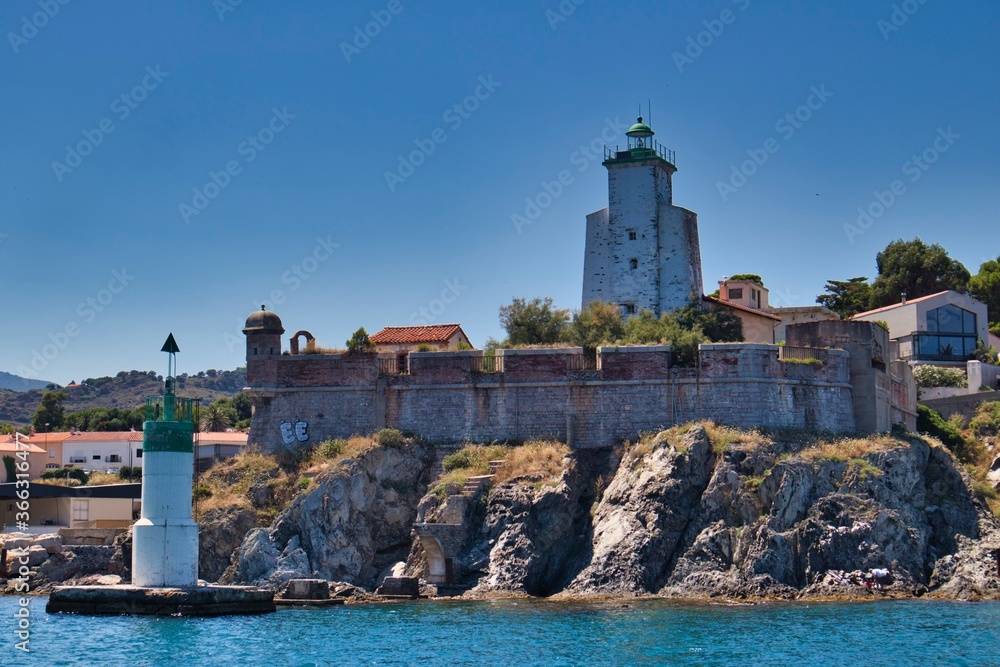 Fort of port Vendre, classed landmark. with lighthouse and fortification over a blue sea and under a blue sky