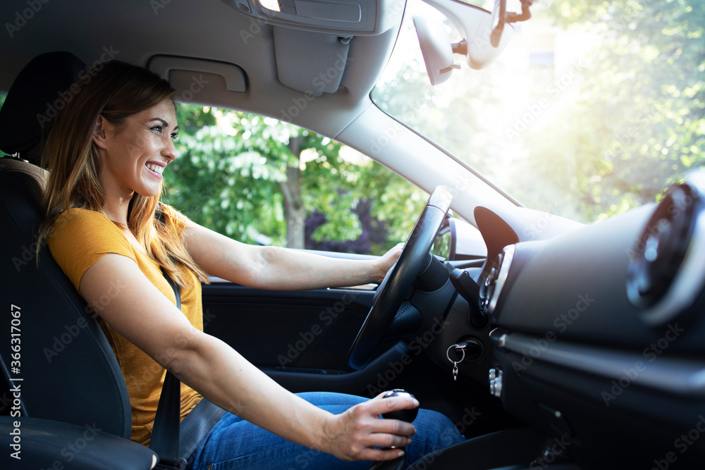 Car interior view of female driver enjoys driving a car. Woman driving automobile. Car interior view of female driver enjoys driving a car. Woman driving automobile.