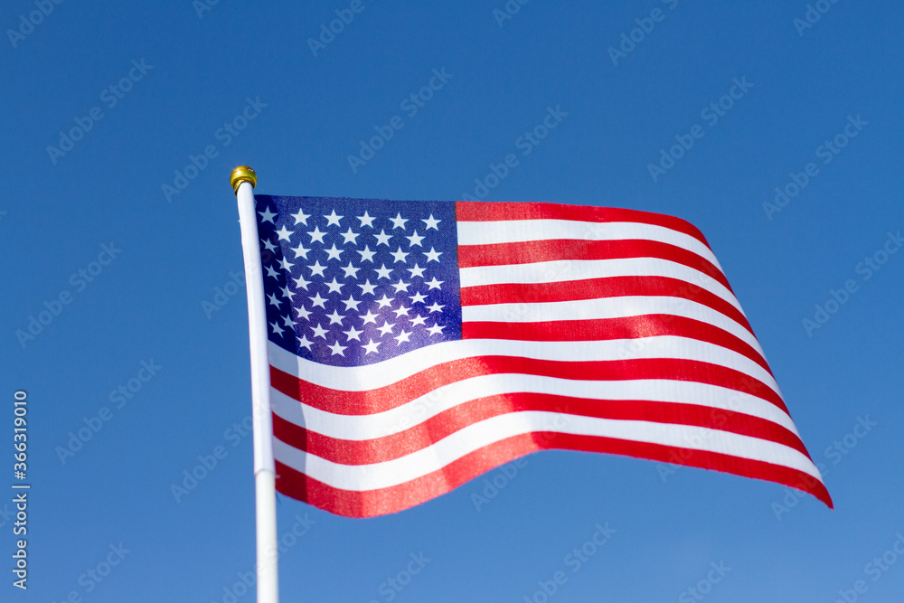 USA flag waving in blue sky. American flag. Celebrating Independence Day of America