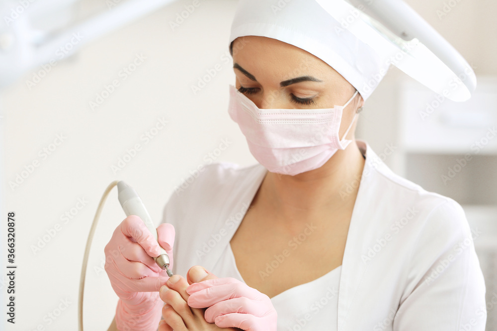 Patient on medical pedicure procedure, visiting podiatrist.Professional