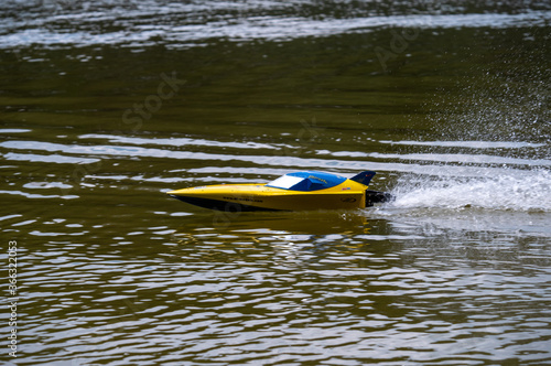 RC controlled jet boat model on lake. Active summer vacation for school child.