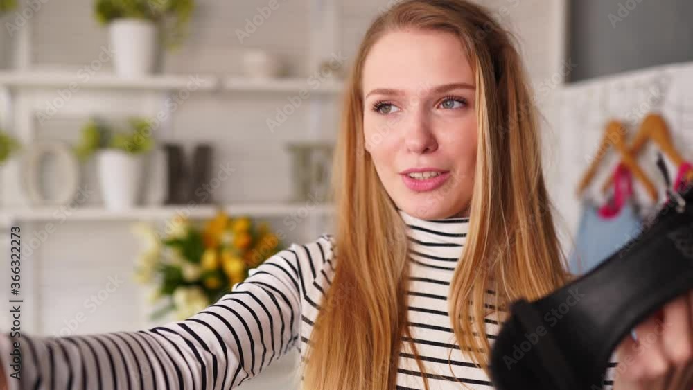 Fashion blogger woman in turtleneck showing high heel shoes on smartphone selfie camera. Stylist influencer girl with trendy footwear filming vlog episode for channel. Opinion leader sets trends. Fashion blogger woman in turtleneck showing high heel shoes on smartphone selfie camera. Stylist influencer girl with trendy footwear filming vlog episode for channel. Opinion leader sets trends.