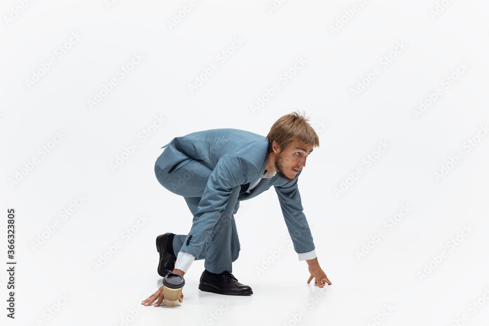 Start up. Man in office clothes running, jogging on white background like professional athlete, sportsman. Unusual look for businessman in motion, action with ball. Sport, healthy lifestyle Start up. Man in office clothes running, jogging on white background like professional athlete, sportsman. Unusual look for businessman in motion, action with ball. Sport, healthy lifestyle