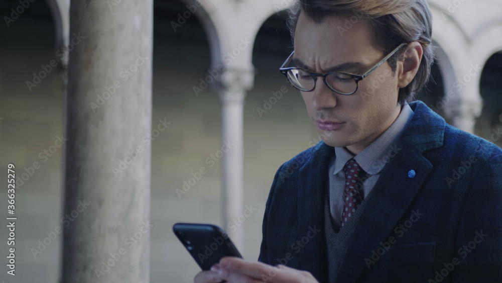 Student reading bad news on cellphone. Businessman working on smartphone Student reading bad news on cellphone. Businessman working on smartphone