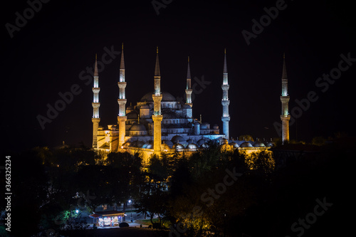 View of six minaret Blue Mosque of Ottoman architecture illuminated by night in Istanbul, Turkey