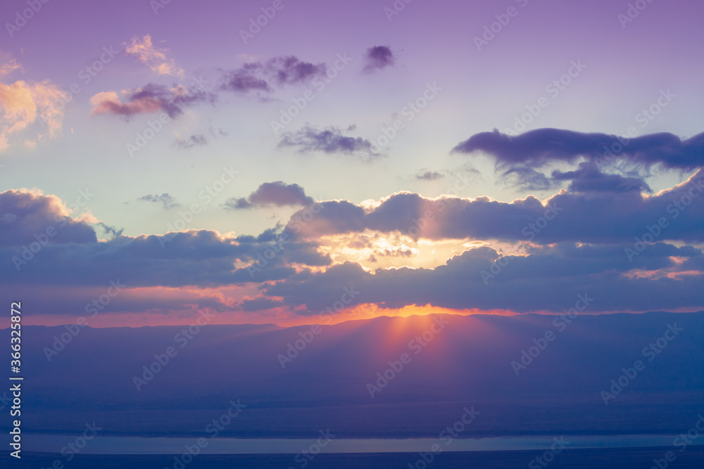 Beautiful sunrise over the Judaean desert. Morning sky with clouds and sun. Israel