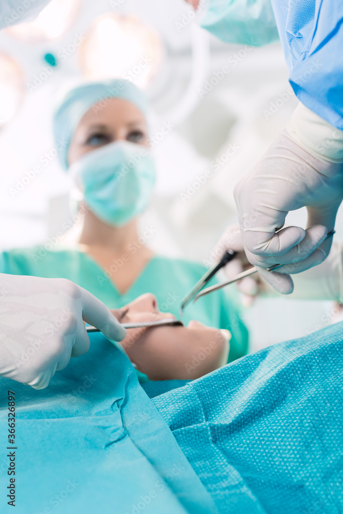 Surgeons operating patient in operation theater Surgeons operating patient in operation theater