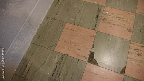 Overhead View of Damaged Cancerous Asbestos Vinyl Flooring that is Cracked Broke