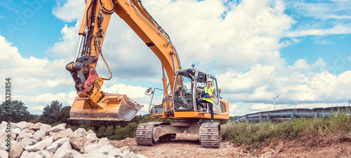 Woman construction worker with excavator on sit