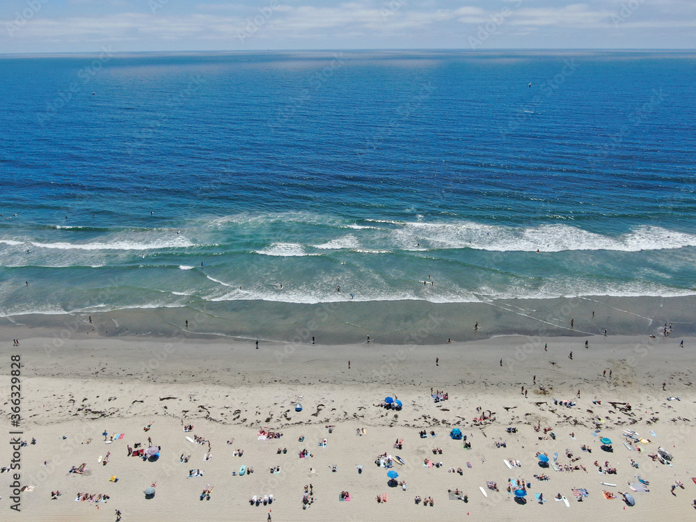 Aerial view of people at the beach during blue summer day. Pacific Beach in San Diego, California 