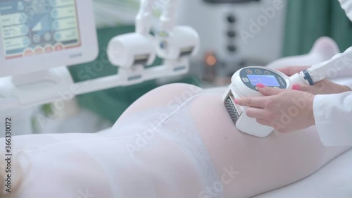 Adult woman having anti cellulite slimming treatment in beauty clinic