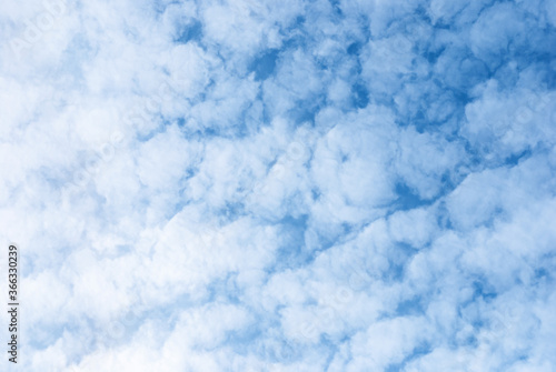white fleecy clouds in blue sky, altocumulus fluffy clouds background photo