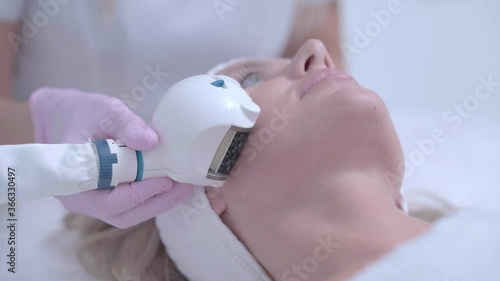Professional cosmetologist woman doing hydrogen face purification