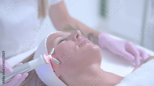 Professional cosmetologist woman doing hydrogen face purification