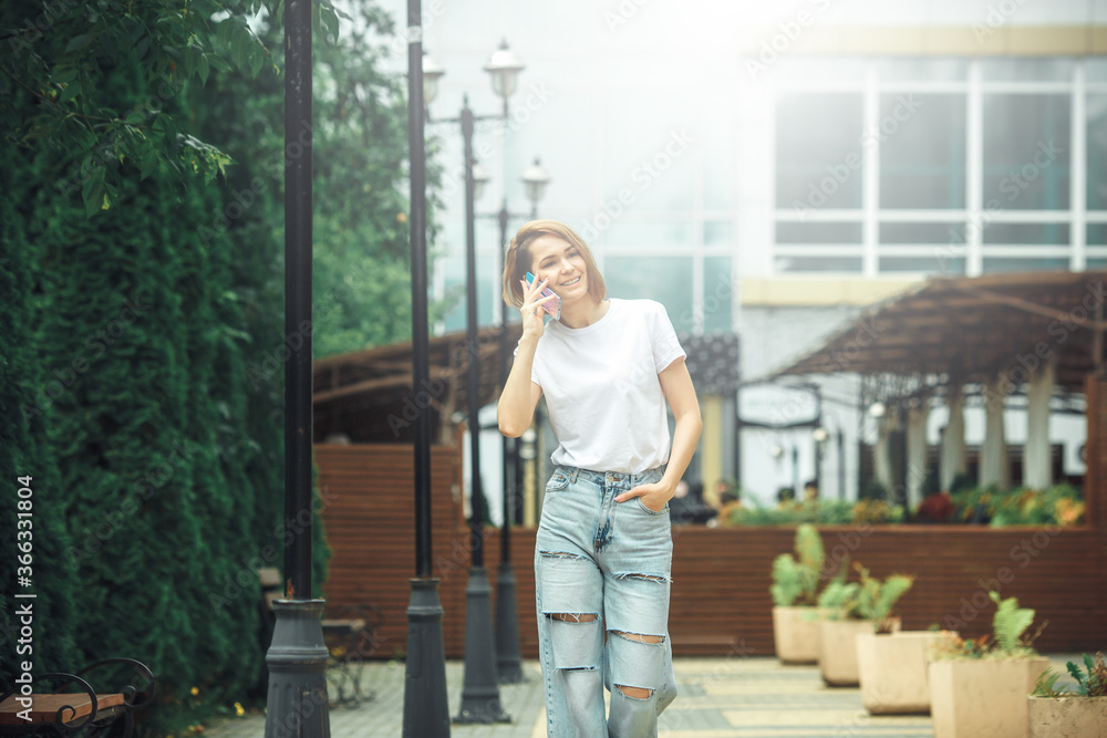 Fototapeta premium Fashion hipster cool girl relaxing on city street