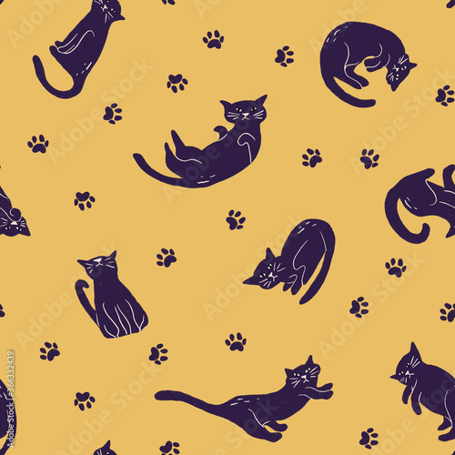 Black cat with paw footprints seamless pattern on yellow background in childish style. Texture for kids fabric  wrapping  textile  wallpaper  apparel. 