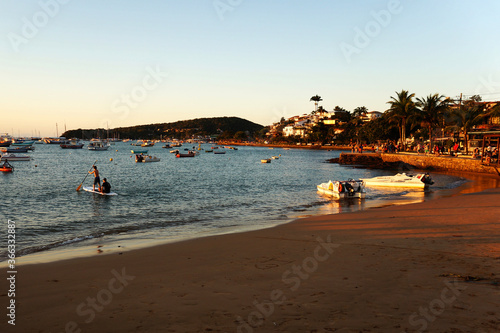 People enjoying sunset at Buzios beach, Brasil photo