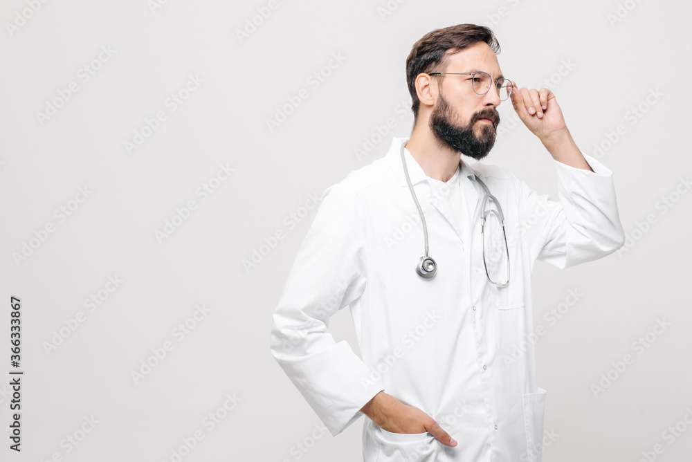 close-up portrait of young male doctor in uniform with stethoscope looks to the right. space for text.. medical concept close-up portrait of young male doctor in uniform with stethoscope looks to the right. space for text.. medical concept