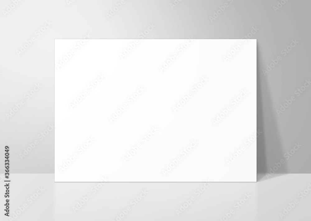 Fototapeta premium グレーの壁に立てかけたシンプルな白いボード