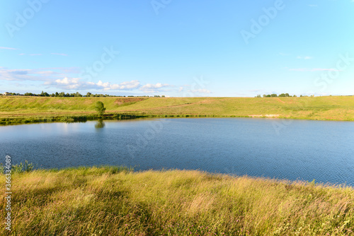 A small reservoir in a ravine on a summer evening