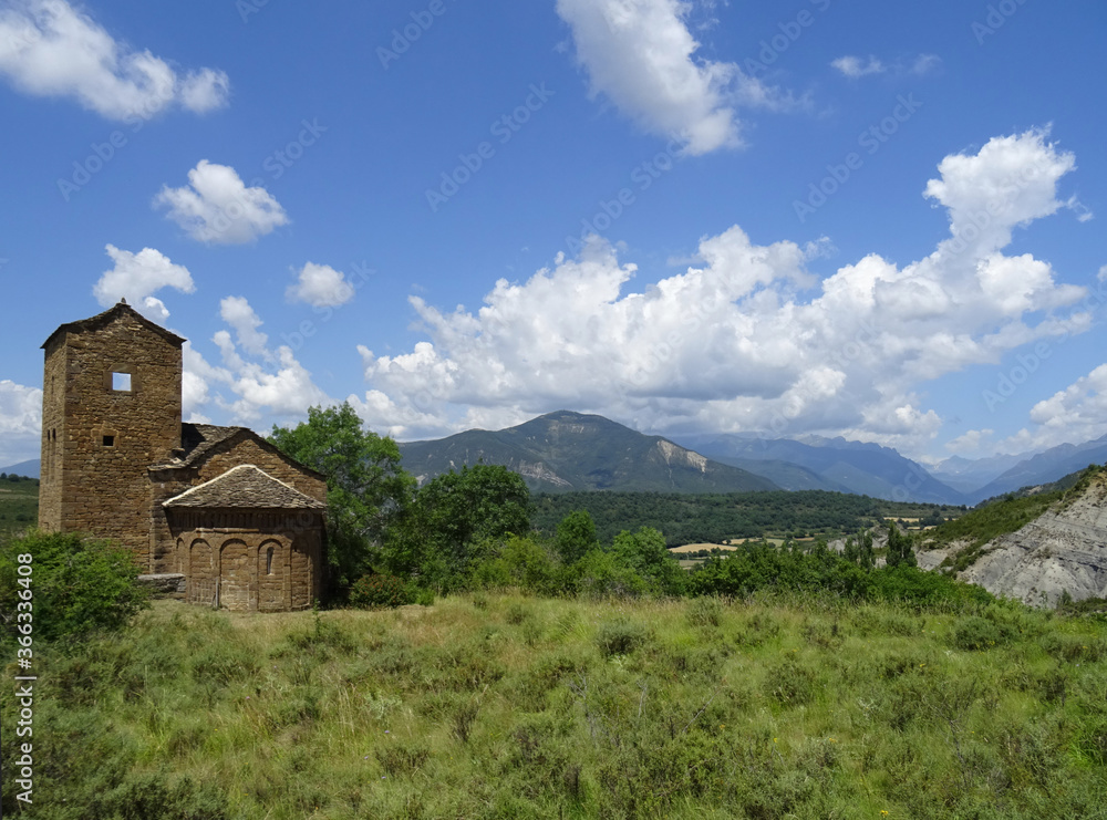 Beautiful landscape with view of the Romanesque Church of San Andres in the village of Satue. 11th century.  Region.Aragon. Spain. 
