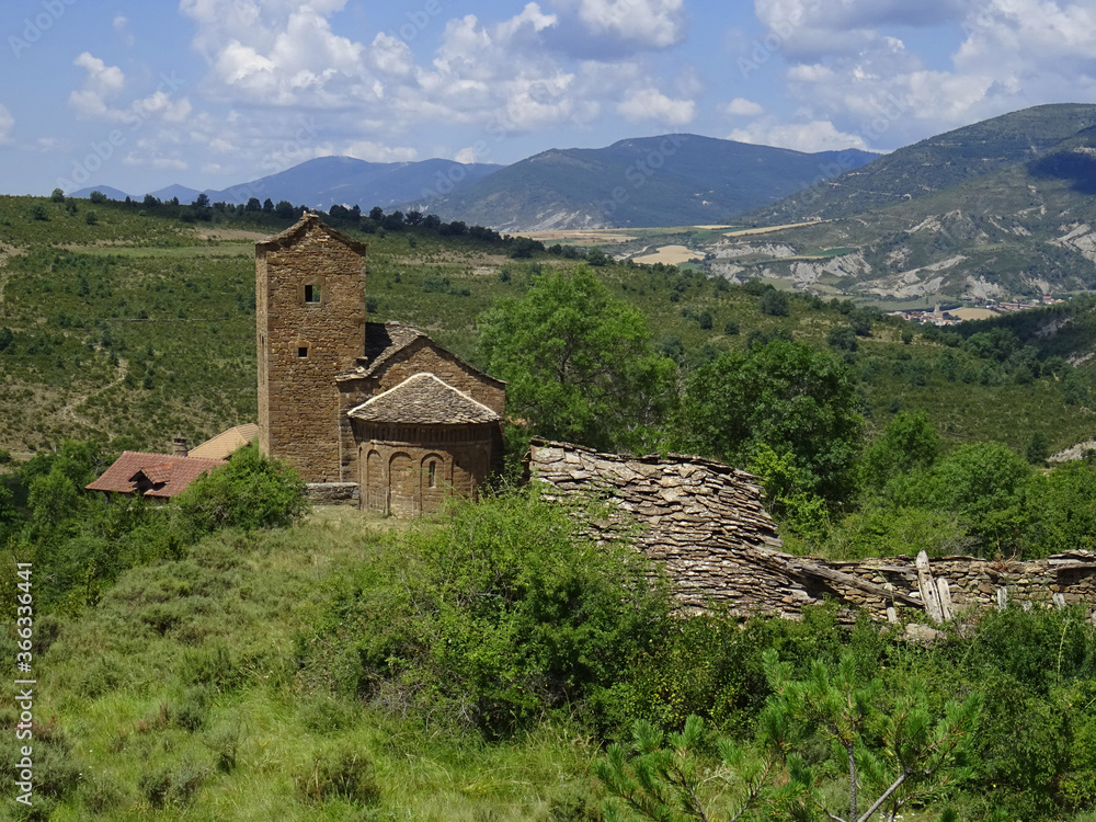 Beautiful landscape with view of the Romanesque Church of San Andres in the village of Satue. 11th century.  Region.Aragon. Spain. 