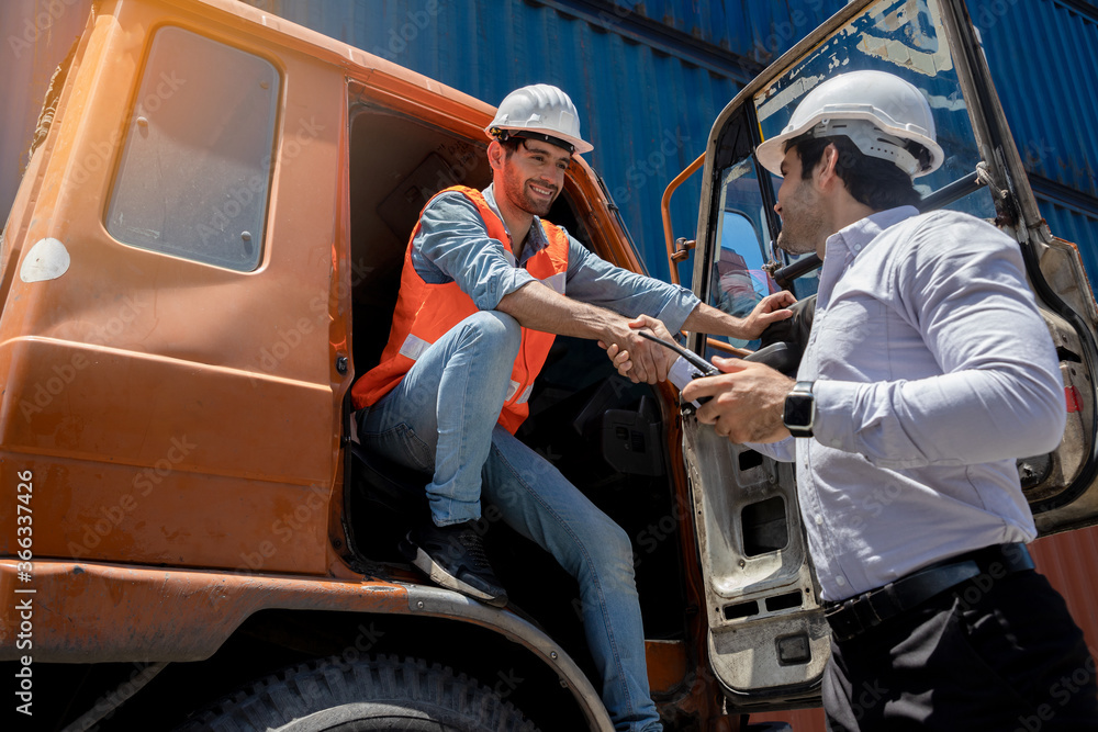 Handsome young engineers using walkie-talkie for communication to control the transportation of products through containers on the job site. Professional supervisor for new business and logistics.