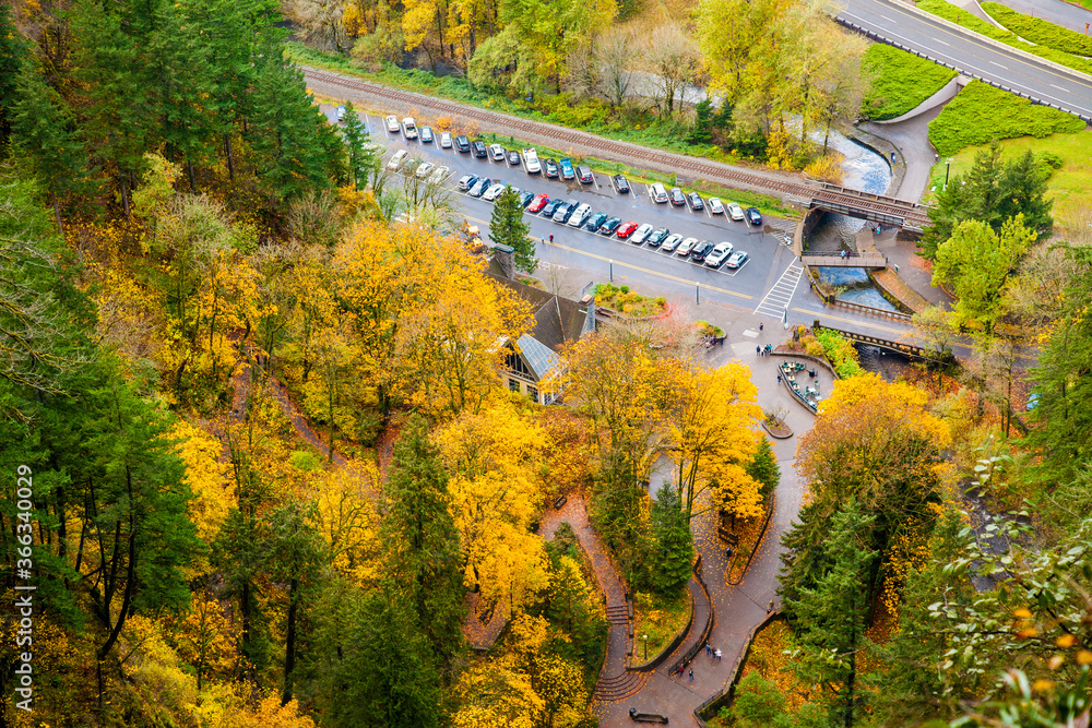 Looking down at the Multnomah Falls lodge, parking lot and paved trails.