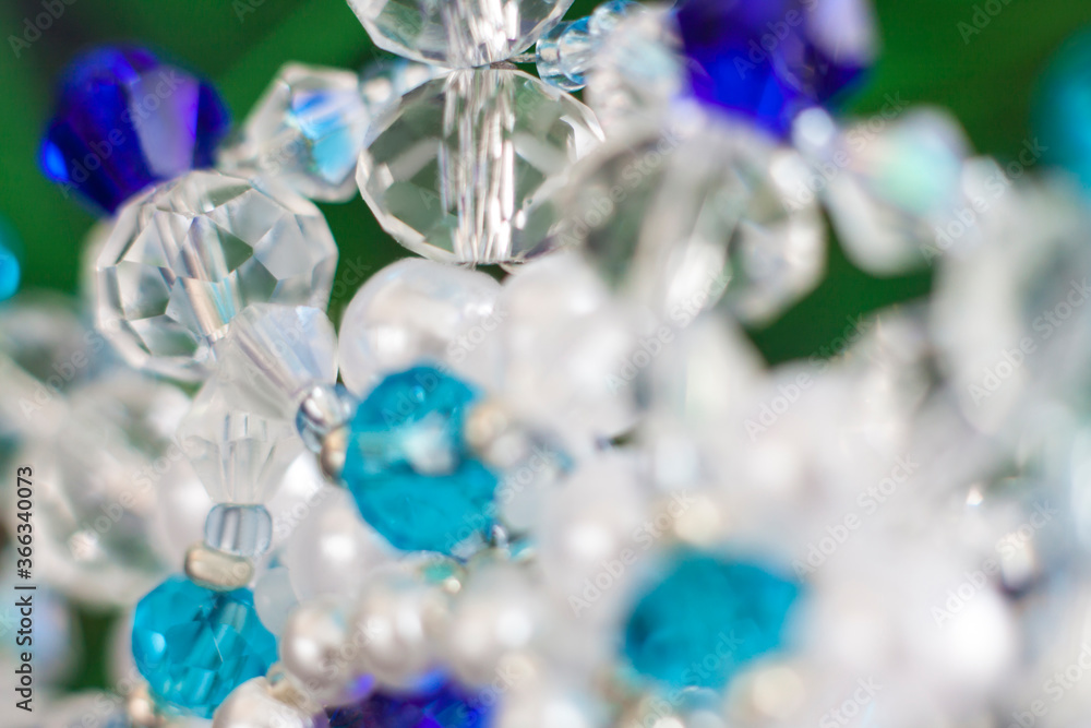 Background of abstract glittering lights. Blurred crystal beads for the background. de-focus. Use it as a background for your presentation. Background of abstract glittering lights. Blurred crystal beads for the background. de-focus. Use it as a background for your presentation.