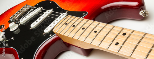 Electric guitar close up on white background maple fretboard.