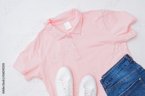 Flat lay female fashion look with stylish clothes and accessories on a light background