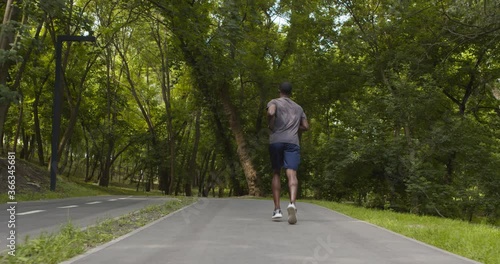 Wallpaper Mural Active african american guy running on port path in park Torontodigital.ca