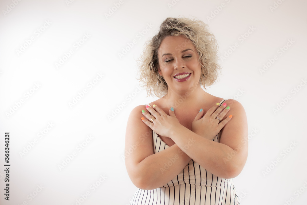 Blonde young woman smiling with her hands crossed Blonde young woman smiling with her hands crossed
