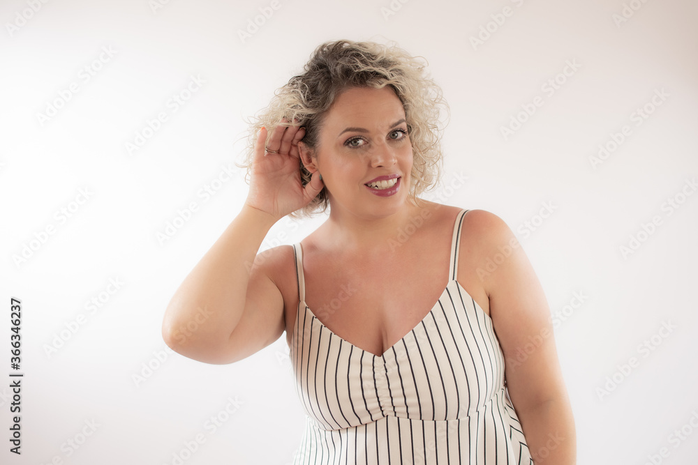 Fototapeta premium Blonde young woman making listening gesture
