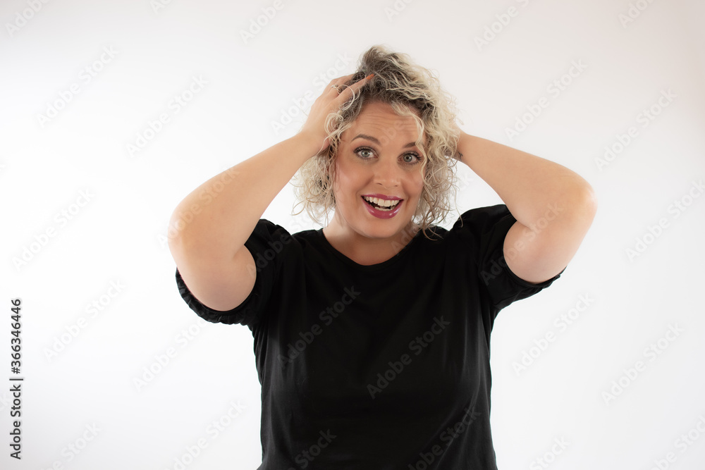 Fototapeta premium Blonde young woman smiling with surprise gesture