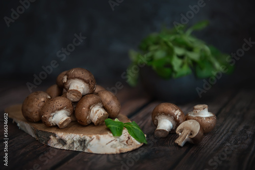 Royal mushrooms on a wooden table and planks of birch log. Image with selective focus