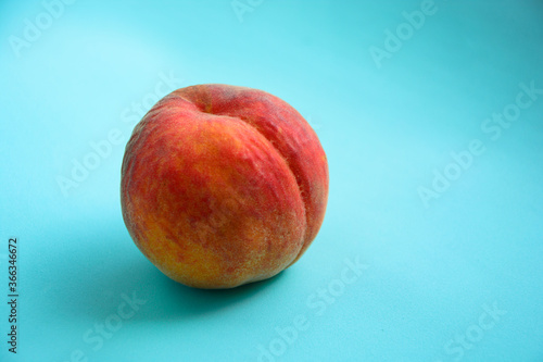 Fresh peach on light blue background,close up. Summer fruit. Summer concepte