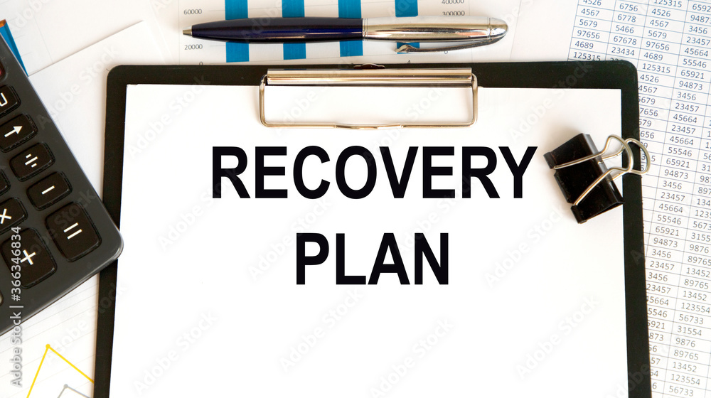 Recovery Plan word written on paper. On the background of accounting, charts and glasses.