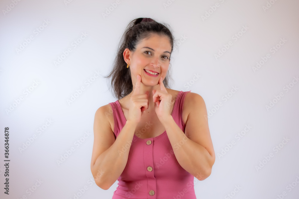 Beautiful young woman in pink shirt smiling Beautiful young woman in pink shirt smiling