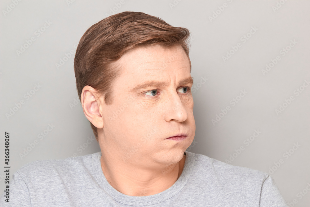 Portrait of disappointed man sighing sadly, looking tired and bored Portrait of disappointed man sighing sadly, looking tired and bored