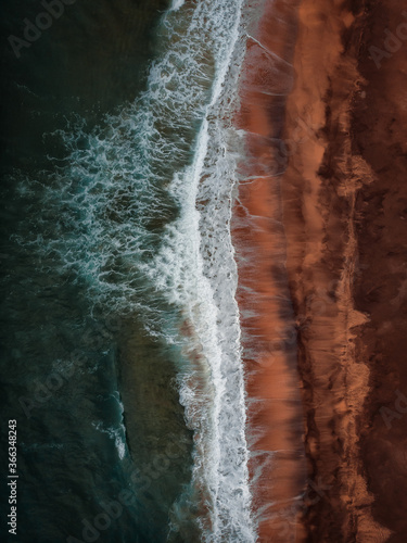 Raudisandur Beach with red sand, aerial view from drone, West Fjords or The Westfjords region in north Iceland. Nature landscape from above