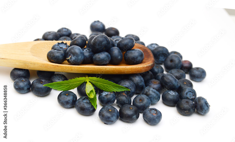 Blue berry and wooden spoon on white background Blue berry and wooden spoon on white background