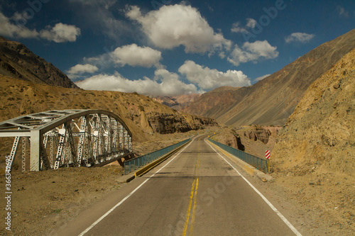 Transport. Rural asphalt highway. View of the desert road and bridge across the mountains. 