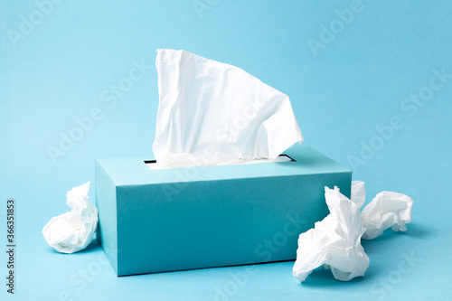 Fototapete Cold and flu concept with a tissue box and crumpled tissues