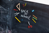 Back to school concept. Chalkboard background. Hand and education tools. 